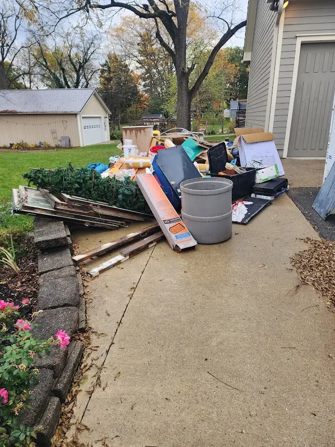 Dumpster being loaded with debris for Roofing Dumpster Rental in Camdenton
